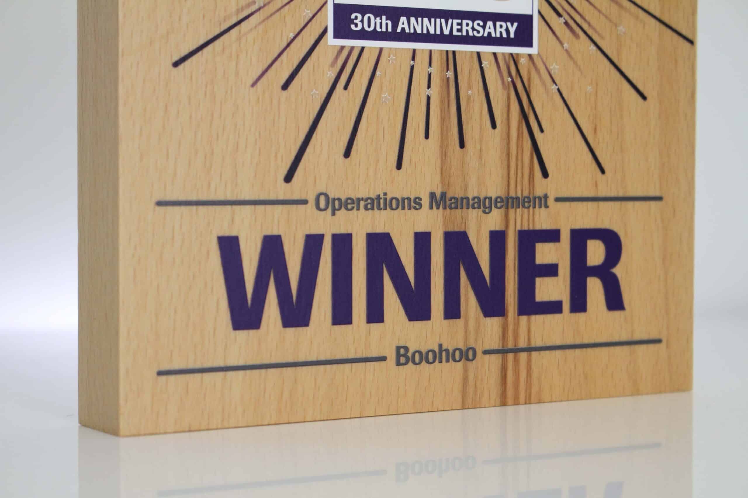 Winner details on custom wooden trophy for CILT Awards
