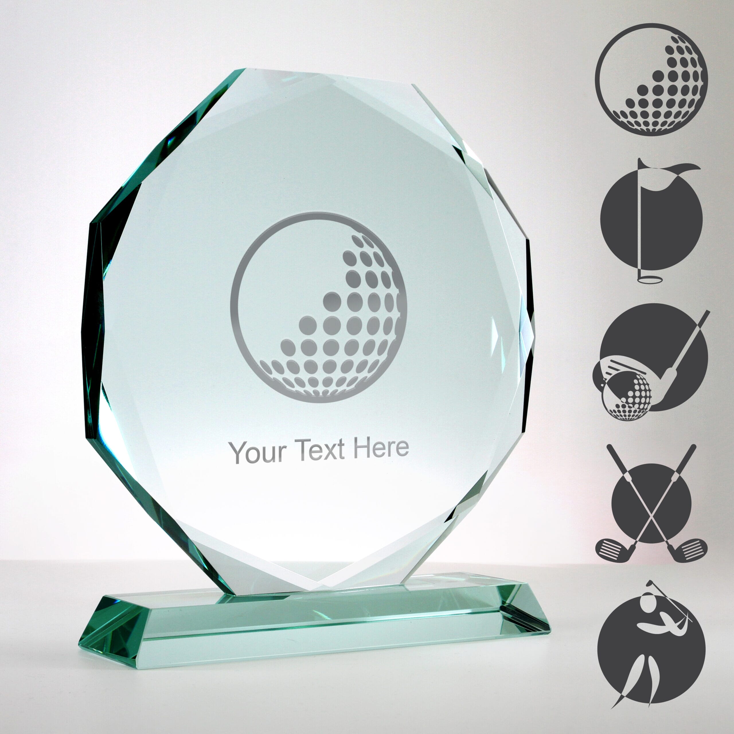facetted glass golf trophy with examples of golf-themed artwork engraved on the surface