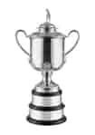 hand chased silver golf trophy on a two-tiered base, topped with a traditional golf figure
