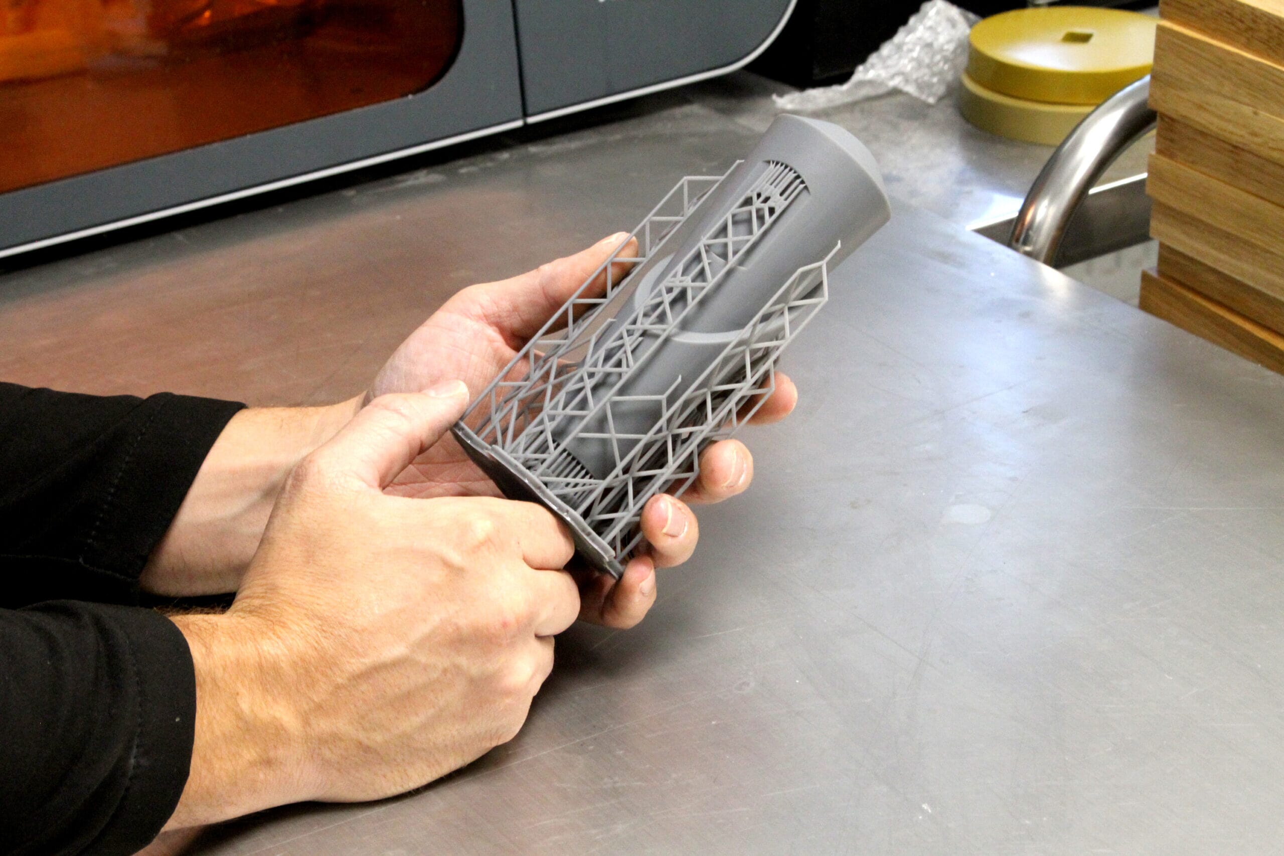 A custom trophy maker removing supports on the 3D printed Living Christ Mission at 40 Trophy