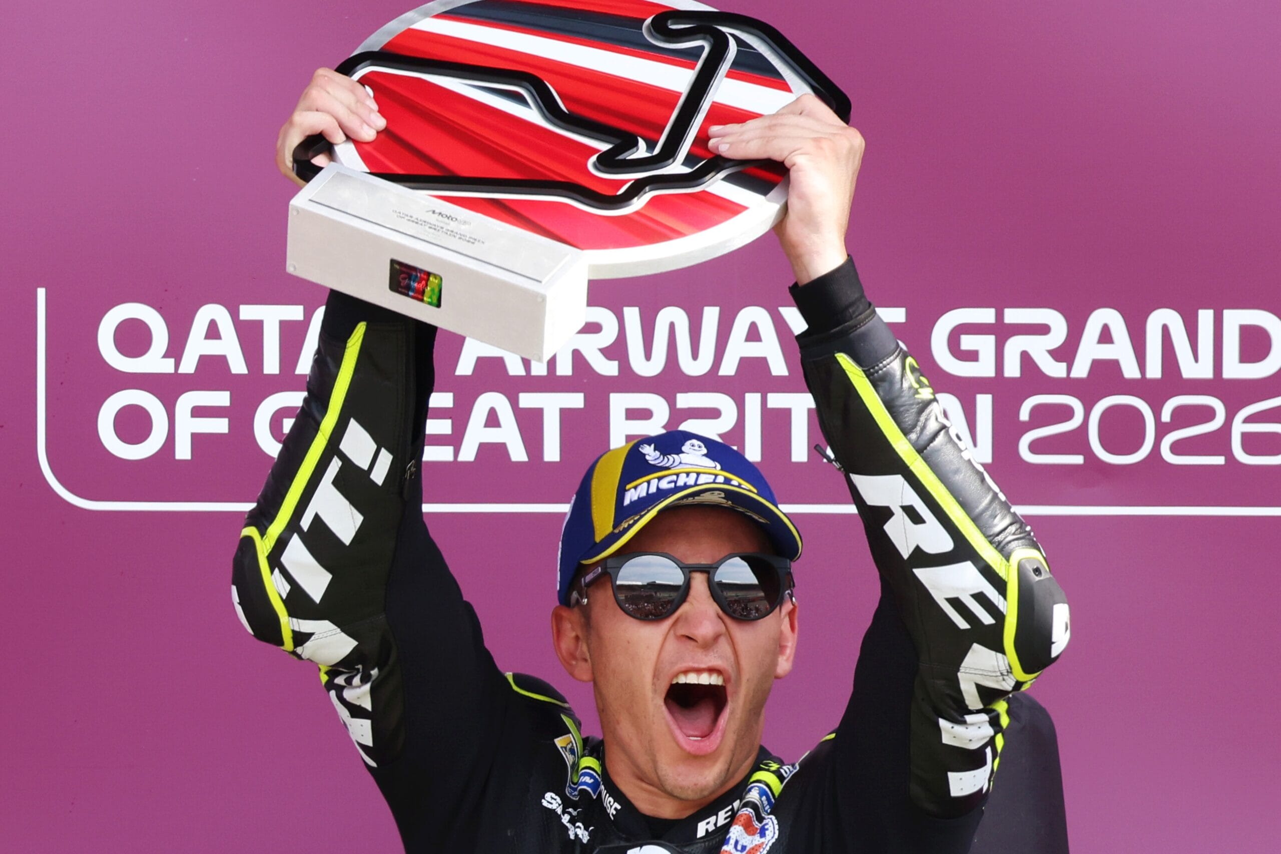 GA018102-MotoGP-Event-Photos-1-Winner-Holding-Trophy-scaled